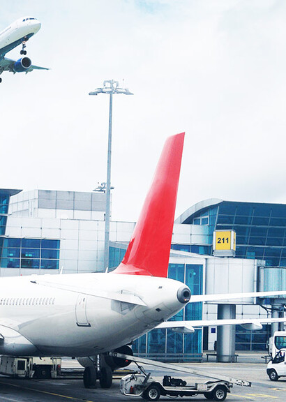Exterior of large modern glass airport building with smart glass windows.