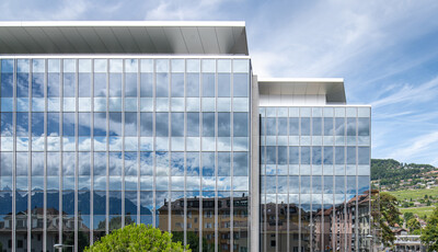 Bâtiment avec des fenêtres intelligentes de gauche à droite sur un grand bâtiment en verre moderne.